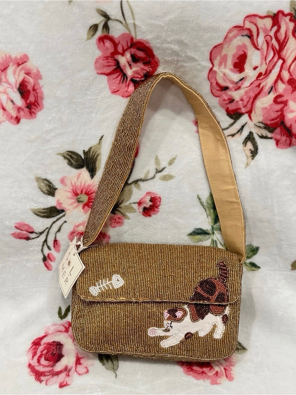 Sol & Mer gold beaded shoulder bag featuring a calico cat